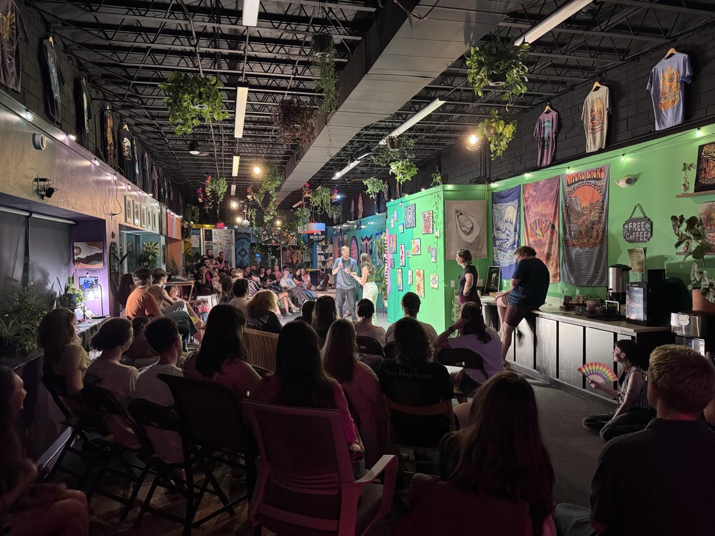 The crowd at a Critter Fight show, the gallery lit up behind them